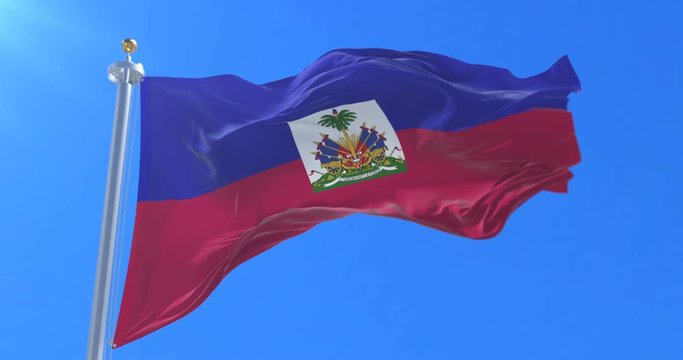 Flag of Haiti waving at wind with blue sky, loop