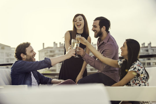Friends drinking champagne together outdoors