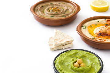 Different hummus bowls. Chickpea hummus, avocado hummus and lentils hummus isolated on white background