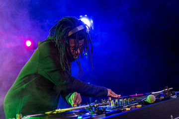 Obraz na płótnie Canvas DJ in headphones with sound mixer