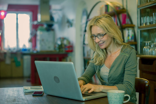 Woman using laptop computer at home