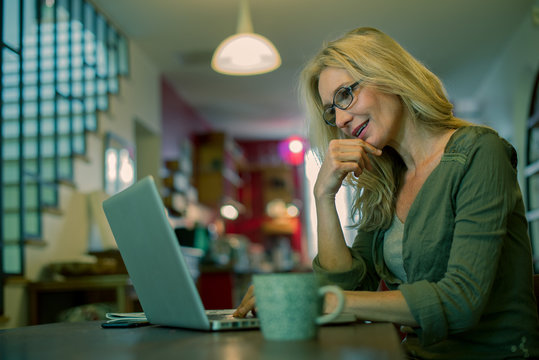 Woman using laptop computer at home