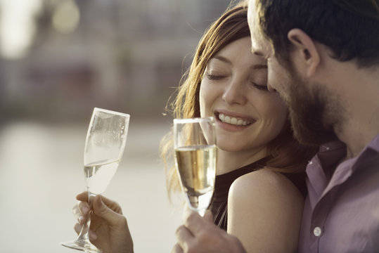 Couple celebrating with champagne outdoors