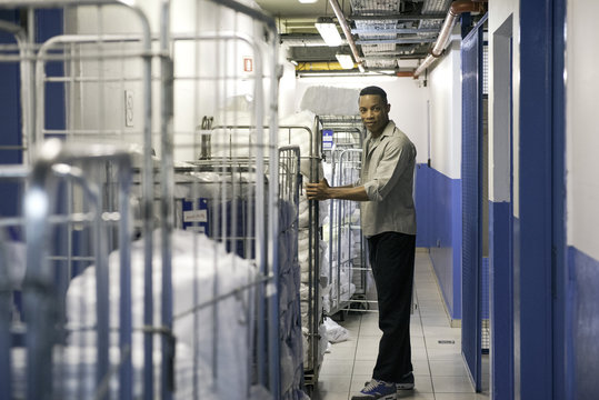 Man with cart of bath towels