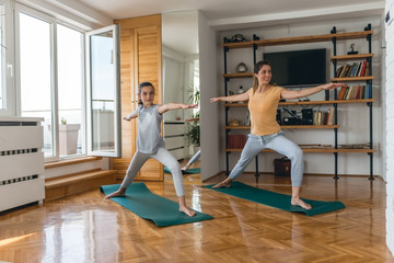 Fototapeta na wymiar Mother and daughter work out home together