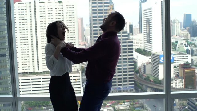 Husband murdering his wife by window at home
