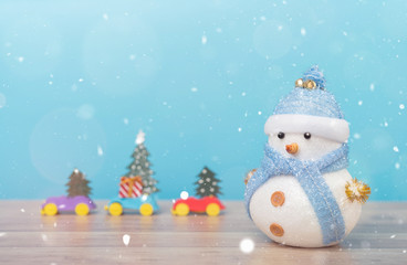 Happy snowman standing in winter christmas snow background. Merry christmas and happy new year greeting card with copy-space. Christmas celebration holiday background.