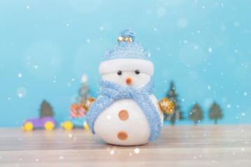Happy snowman standing in winter christmas snow background. Merry christmas and happy new year greeting card with copy-space. Christmas celebration holiday background.