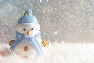 Happy snowman standing in winter christmas snow background. Merry christmas and happy new year greeting card with copy-space. Christmas celebration holiday background.