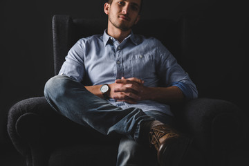 man relaxing in armchair