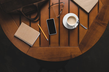 smartphone, notepad and cup of coffee
