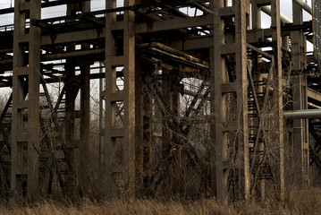 the construction of old concrete pipeline supports, standing in the middle of a dry winter bush