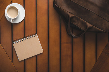 leather bag, notepad and coffee