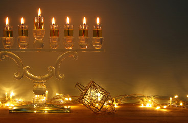 image of jewish holiday Hanukkah background with menorah (traditional candelabra) and burning candles. © tomertu