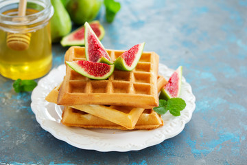 Homemade waffles with caramel sauce, figs and raspberries.