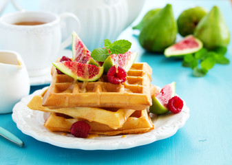 Homemade waffles with caramel sauce, figs and raspberries.