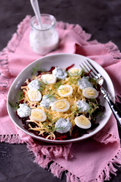 Healthy salad from boiled beetroot, hard cheese, quail eggs and dressings from natural yogurt with dill, black pepper and sea salt.