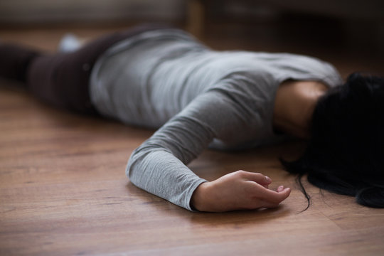 Dead Woman Body Lying On Floor At Crime Scene