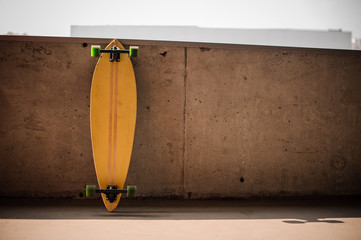 Photo of the flat yellow longboard with green wheels © fesenko