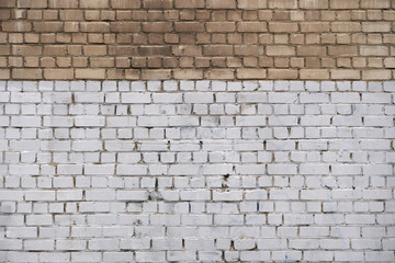 The wall is made of bricks.  It is painted white.  Not a painted brick.  Background.  Exterior