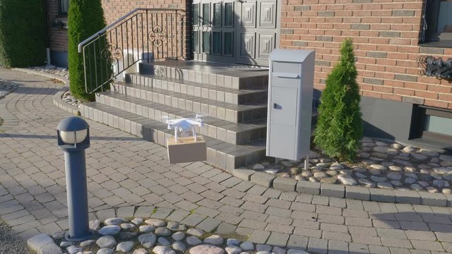 drone in front of a house pick up package and fly away