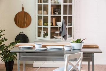 beautiful kitchen white wall white kitchen cupboard and metallic table with all kind of kitchen accessories