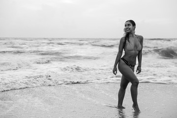 Black and white image of a woman looking over her shoulder and smiling