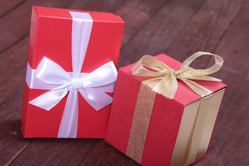 Gift boxes with bow and christmas decoration on wood background