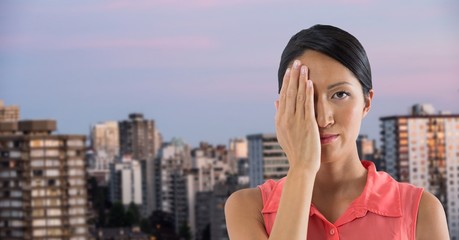 Fototapeta premium Businesswoman covering eye with hand in city