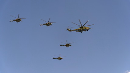 Combat helicopters Mi-26 and Mi-8 fly in sky