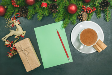Christmas background with blank notebook, fir branches, decorations and gift boxes. Space for text. Top view. Christmas to-do list or wish list.