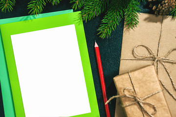 Christmas background or Xmas card  with decorations fir, gift box and ornamen. Space for Holiday Greetings.  Top view. Goal, planning winter holiday