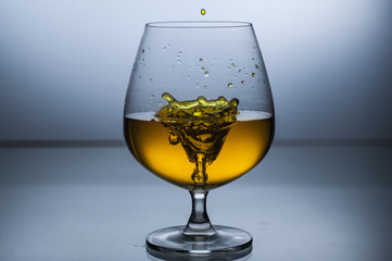 Wine glass splashing in glass