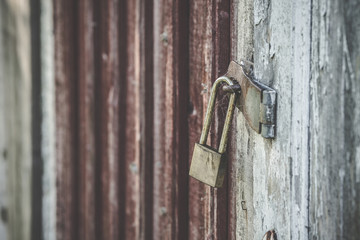 Old lock on a wooden door in golden color