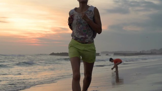Family having fun on the beach, steadycam shot, slow motion shot at 240fps
