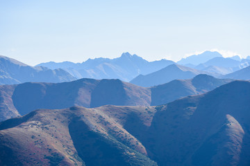 mountain tops in  autumn covered in mist or clouds