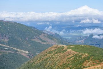Obraz premium mountain tops in autumn covered in mist or clouds