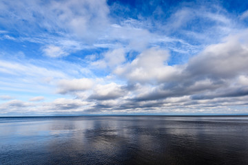 Shoreline of Baltic sea beach with rocks and sand dunes