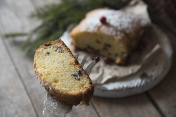 sliced cranberry cake on the wooden background and tree branch 