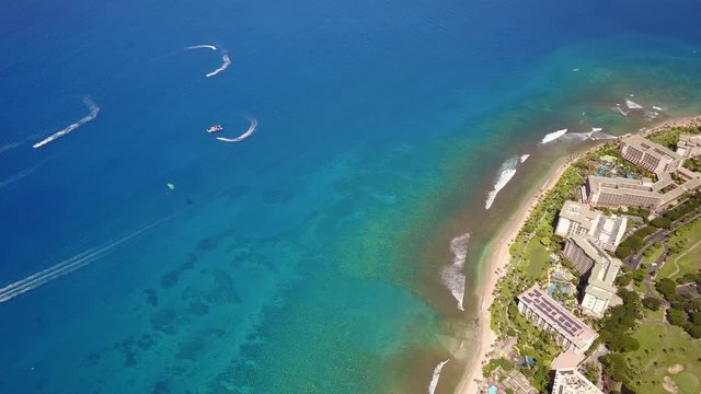 Aerial shot of crystal clean ocean,boats and fashionable hotels ont he coastline of Hawaii