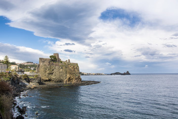 Fototapeta na wymiar Aci Castello castle with Acitrezza background