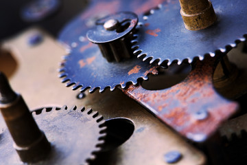 Cogs wheels machinery, rusty iron mechanism. Black metal gears close-up photo. Shallow depth field. Selective focus