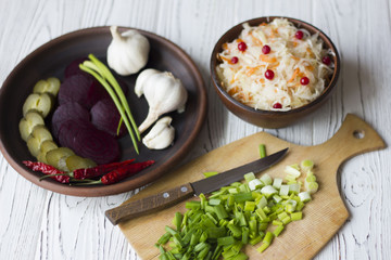 sauersauerkraut and vegetables : onions, garlic, cucumbers, beets, chili peppers on the table