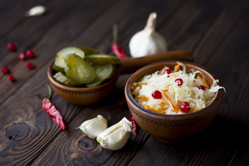 sauerkraut with cranberries and vegetables : garlic, cucumber, chili peppers on the table