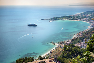 Fototapeta na wymiar Cruise ship on the Mediterranean sea in front Taormina Sicily