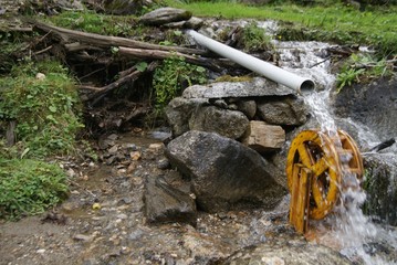 Photo of home-made watermill in Vals valley, Tirol, Austria. August 2017 Water flows through tube,...