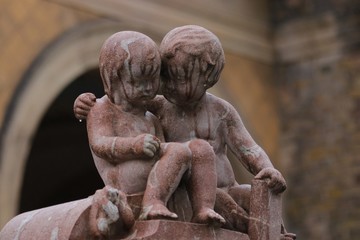 tomb statues of big brother comforting his crying and grieving young brother, sympathy message