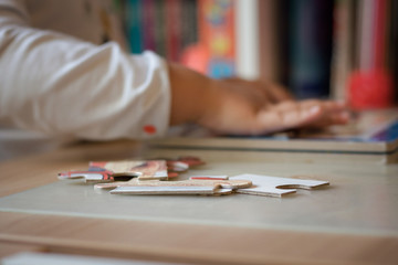 Jigsaw puzzle with child in the background.