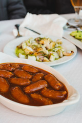 Pork sausages, in barbecue sauce at the source, on the restaurant