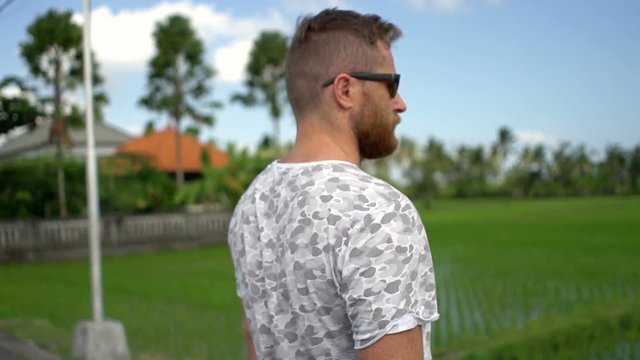 Man standing in the exotic place and feels free, steadycam shot, slow motion shot at 240fps
